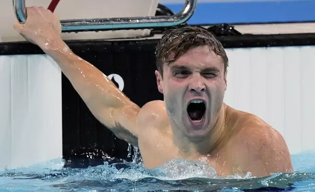 United States' Bobby Finke celebrates winning the gold medal in the men's 1500-meter freestyle final at the Summer Olympics in Nanterre, France, Sunday, Aug. 4, 2024. (AP Photo/Brynn Anderson)