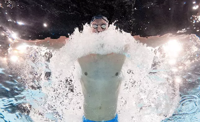 Leon Marchand, of France, competes during a heat in the men's 200-meter butterfly at the 2024 Summer Olympics, Tuesday, July 30, 2024, in Nanterre, France. (AP Photo/David J. Phillip)