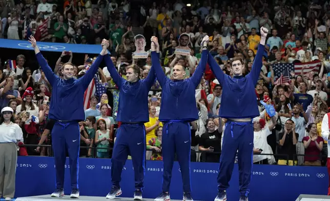 United States' Ryan Murphy, Nic Fink, Caeleb Dressel, and Hunter Armstrong celebrate winning the silver medal on the podium for the men's 4x100-meter medley relay at the Summer Olympics in Nanterre, France, Sunday, Aug. 4, 2024. (AP Photo/Natacha Pisarenko)