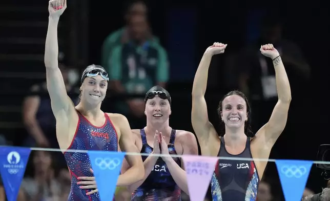 United States' Gretchen Walsh, from left, Lilly King and Regan Smith celebrate winning the gold medal in the women's 4x100-meter medley relay final at the Summer Olympics in Nanterre, France, Sunday, Aug. 4, 2024. (AP Photo/Natacha Pisarenko)