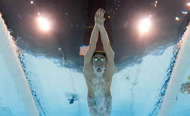 Kristof Milak, of Hungary, competes during a heat in the men's 200-meter butterfly at the 2024 Summer Olympics, Tuesday, July 30, 2024, in Nanterre, France. (AP Photo/David J. Phillip)