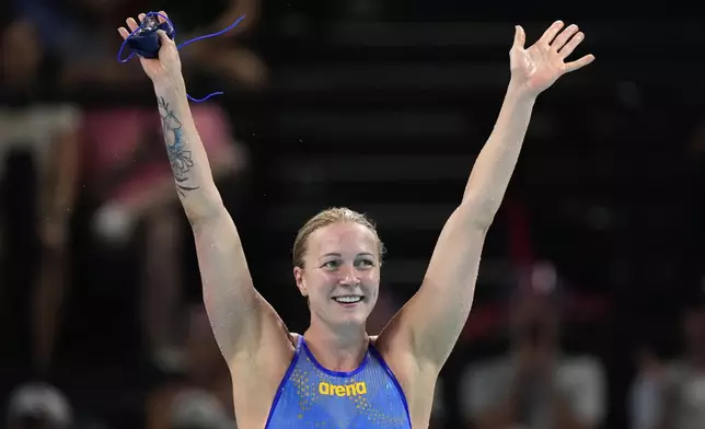 Sweden's Sarah Sjoestroem celebrates after winning the gold medal in the women's 50-meter freestyle final at the Summer Olympics in Nanterre, France, Sunday, Aug. 4, 2024. (AP Photo/Brynn Anderson)