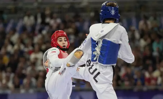 Bulgaria's Kimia Alizadeh Zenozi competes with Iran's Nahid Kiyanichandeh in a women's 57kg Taekwondo match during the 2024 Summer Olympics, at the Grand Palais, Thursday, Aug. 8, 2024, in Paris, France. (AP Photo/Andrew Medichini)