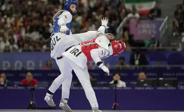 Bulgaria's Kimia Alizadeh Zenozi competes with Iran's Nahid Kiyanichandeh in a women's 57kg Taekwondo match during the 2024 Summer Olympics, at the Grand Palais, Thursday, Aug. 8, 2024, in Paris, France. (AP Photo/Andrew Medichini)