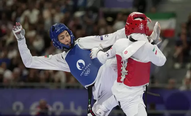 Bulgaria's Kimia Alizadeh Zenozi competes with Iran's Nahid Kiyanichandeh in a women's 57kg Taekwondo match during the 2024 Summer Olympics, at the Grand Palais, Thursday, Aug. 8, 2024, in Paris, France. (AP Photo/Andrew Medichini)