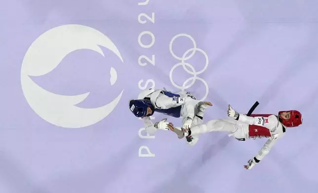 Bulgaria's Kimia Alizadeh Zenozi competes with Iran's Nahid Kiyanichandeh in a women's 57kg Taekwondo match during the 2024 Summer Olympics, at the Grand Palais, Thursday, Aug. 8, 2024, in Paris, France. (AP Photo/Andrew Medichini)