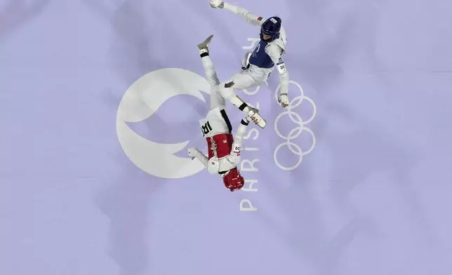 Bulgaria's Kimia Alizadeh Zenozi competes with Iran's Nahid Kiyanichandeh in a women's 57kg Taekwondo match during the 2024 Summer Olympics, at the Grand Palais, Thursday, Aug. 8, 2024, in Paris, France. (AP Photo/Andrew Medichini)