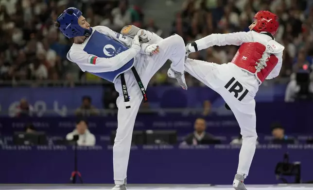 Bulgaria's Kimia Alizadeh Zenozi competes with Iran's Nahid Kiyanichandeh in a women's 57kg Taekwondo match during the 2024 Summer Olympics, at the Grand Palais, Thursday, Aug. 8, 2024, in Paris, France. (AP Photo/Andrew Medichini)