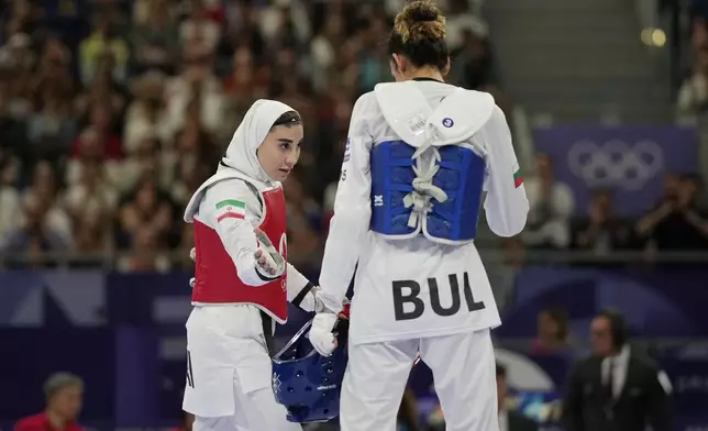 Iran's Nahid Kiyanichandeh, left, reacts at the end of a women's 57kg Taekwondo match against Bulgaria's Kimia Alizadeh Zenozi during the 2024 Summer Olympics, at the Grand Palais, Thursday, Aug. 8, 2024, in Paris, France. (AP Photo/Andrew Medichini)