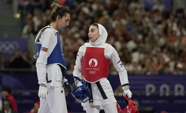 Iran's Nahid Kiyanichandeh, right, reacts at the end of a women's 57kg Taekwondo match against Bulgaria's Kimia Alizadeh Zenozi during the 2024 Summer Olympics, at the Grand Palais, Thursday, Aug. 8, 2024, in Paris, France. (AP Photo/Andrew Medichini)