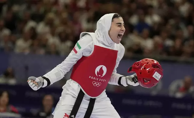 Iran's Nahid Kiyanichandeh reacts at the end of a women's 57kg Taekwondo match against Bulgaria's Kimia Alizadeh Zenozi during the 2024 Summer Olympics, at the Grand Palais, Thursday, Aug. 8, 2024, in Paris, France. (AP Photo/Andrew Medichini)