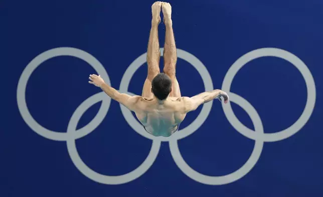 France's Jules Bouyer competes in the men's 3m springboard diving preliminary at the 2024 Summer Olympics, Tuesday, Aug. 6, 2024, in Saint-Denis, France. (AP Photo/Lee Jin-man)