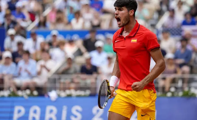 Carlos Alcaraz of Spain celebrates a point against Tommy Paul, of United States during their men's quarter-final match at the Roland Garros stadium, at the 2024 Summer Olympics, Thursday, Aug. 1, 2024, in Paris, France. (AP Photo/Manu Fernandez)