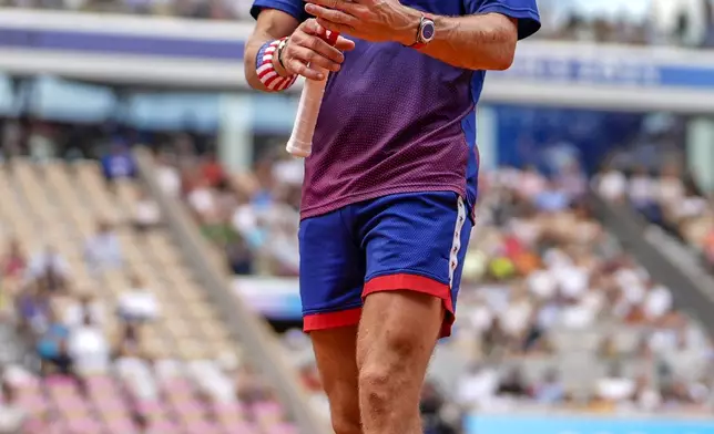 Tommy Paul, of United States prepares to serve against Carlos Alcaraz of Spain during their men's quarter-final match at the Roland Garros stadium, at the 2024 Summer Olympics, Thursday, Aug. 1, 2024, in Paris, France. (AP Photo/Manu Fernandez)