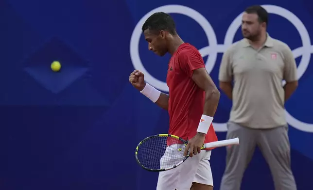 Felix Auger-Aliassime of Canada reacts after scoring a point against Casper Ruud of Norway during their men's singles quarterfinals tennis match, at the 2024 Summer Olympics, Thursday, Aug.1, 2024, at the Roland Garros stadium in Paris, France. (AP Photo/Andy Wong)