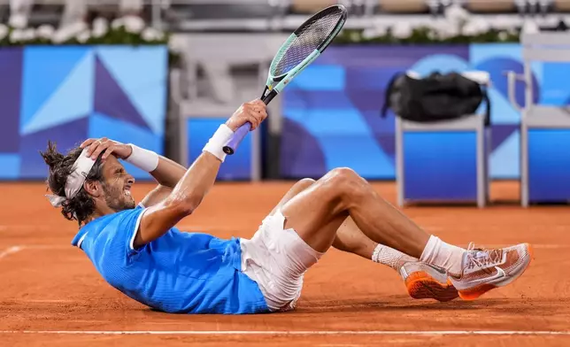 Lorenzo Musetti of Italy reacts after defeating Felix Auger-Aliassime of Canada during men's singles bronze medal tennis match at the Roland Garros stadium, at the 2024 Summer Olympics, Saturday, Aug. 3, 2024, in Paris, France. (AP Photo/Manu Fernandez)