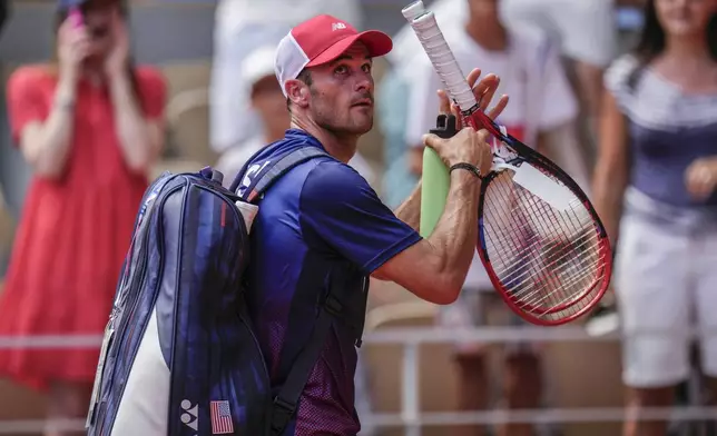 Tommy Paul, of United States leaves the court after losing against Carlos Alcaraz of Spain during their men's quarter-final match at the Roland Garros stadium, at the 2024 Summer Olympics, Thursday, Aug. 1, 2024, in Paris, France. (AP Photo/Manu Fernandez)