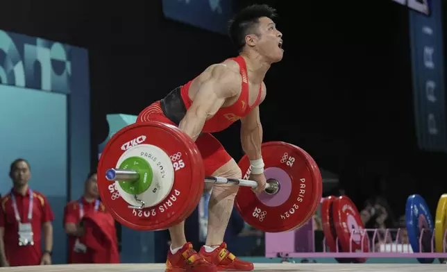 Li Fabin of China competes during the men's 61kg weightlifting event at the 2024 Summer Olympics, Wednesday, Aug. 7, 2024, in Paris, France. (AP Photo/Kin Cheung)