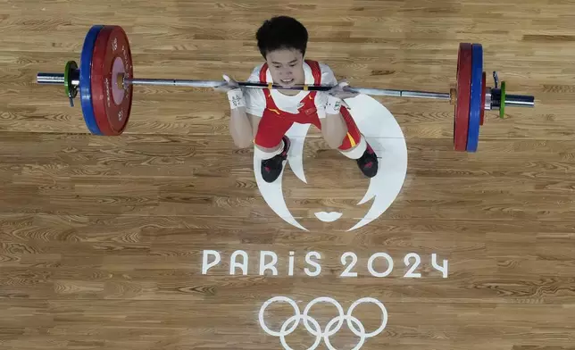 Hou Zhihui of China competes during the women's 49kg weightlifting event at the 2024 Summer Olympics, Wednesday, Aug. 7, 2024, in Paris, France. (AP Photo/Dita Alangkara,Pool)