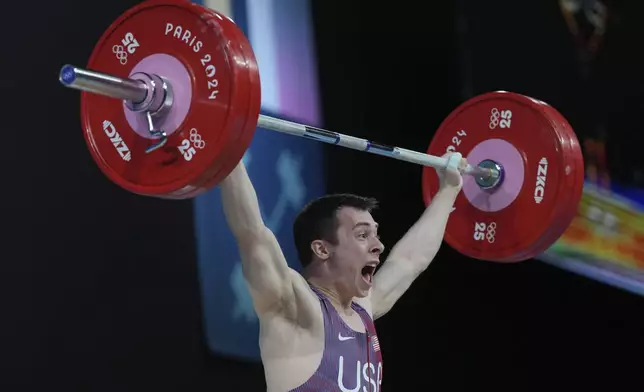 Hampton Morris of the United States competes during the men's 61kg weightlifting event at the 2024 Summer Olympics, Wednesday, Aug. 7, 2024, in Paris, France. (AP Photo/Kin Cheung)