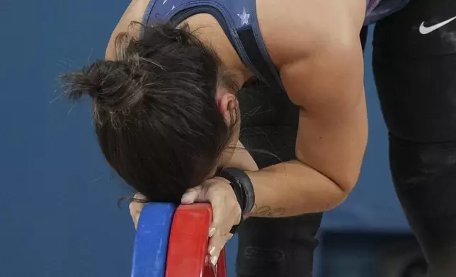 Jourdan Delacruz of the United States reacts as she competes during the women's 49kg weightlifting event at the 2024 Summer Olympics, Wednesday, Aug. 7, 2024, in Paris, France. (AP Photo/Kin Cheung)