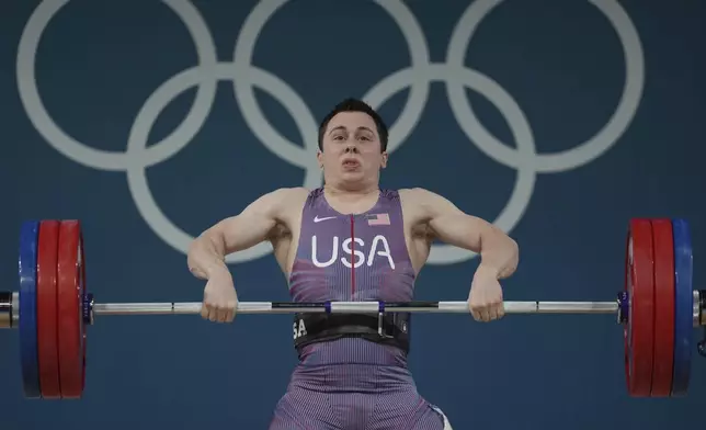 Hampton Morris of the United States competes during the men's 61kg weightlifting event at the 2024 Summer Olympics, Wednesday, Aug. 7, 2024, in Paris, France. (AP Photo/Kin Cheung)