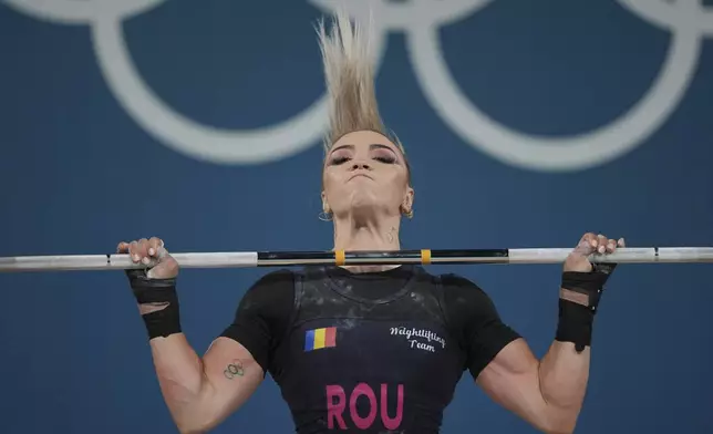 Michaela Valentina Cambei of Romania competes during the women's 49kg weightlifting event at the 2024 Summer Olympics, Wednesday, Aug. 7, 2024, in Paris, France. (AP Photo/Kin Cheung)