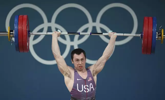 Hampton Morris of the United States competes during the men's 61kg weightlifting event at the 2024 Summer Olympics, Wednesday, Aug. 7, 2024, in Paris, France. (AP Photo/Kin Cheung)