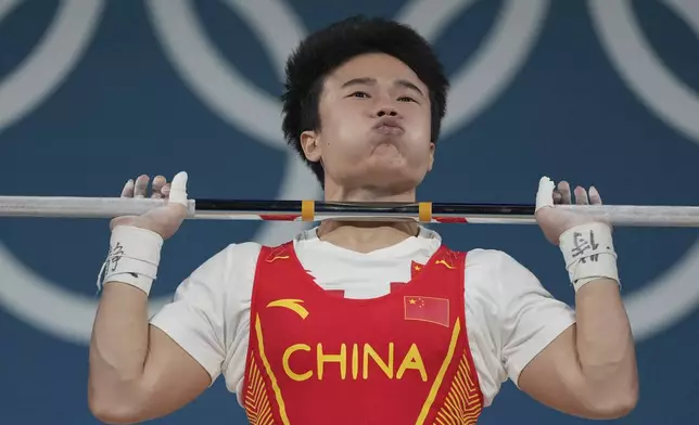 Hou Zhihui of China competes during the women's 49kg weightlifting event at the 2024 Summer Olympics, Wednesday, Aug. 7, 2024, in Paris, France. (AP Photo/Kin Cheung)