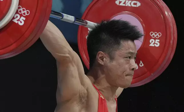 Li Fabin of China competes during the men's 61kg weightlifting at the 2024 Summer Olympics, Wednesday, Aug. 7, 2024, in Paris, France. (AP Photo/Kin Cheung)