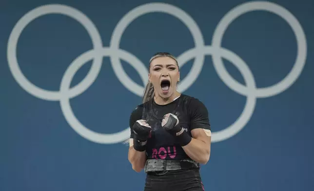 Michaela Valentina Cambei of Romania reacts during the women's 49kg weightlifting event at the 2024 Summer Olympics, Wednesday, Aug. 7, 2024, in Paris, France. (AP Photo/Kin Cheung)