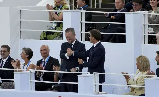 French President Emmanuel Macron, right, and IPC president Andrew Parson shake hands during the Opening Ceremony for the 2024 Paralympics, Wednesday, Aug. 28, 2024, in Paris, France. (AP Photo/Emilio Morenatti)