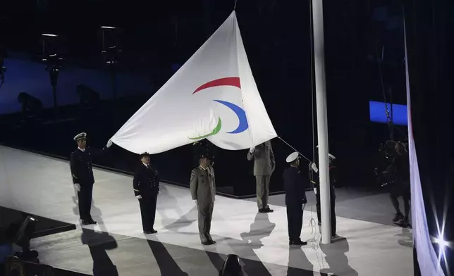 The Paralympic flag is raised during the Opening Ceremony for the 2024 Paralympics, Wednesday, Aug. 28, 2024, in Paris, France. (AP Photo/Thomas Padilla)