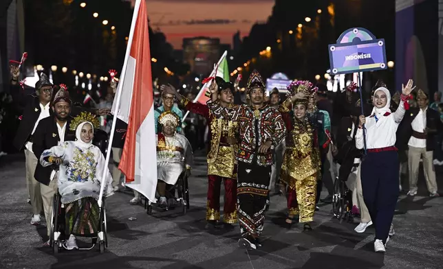 Indonesia's delegation arrives during the Parade of Nations as part of the Paris 2024 Paralympic Games Opening Ceremony at the Place de la Concorde in Paris, France, Wednesday Aug. 28, 2024. (Julien De Rosa/Pool Photo via AP)