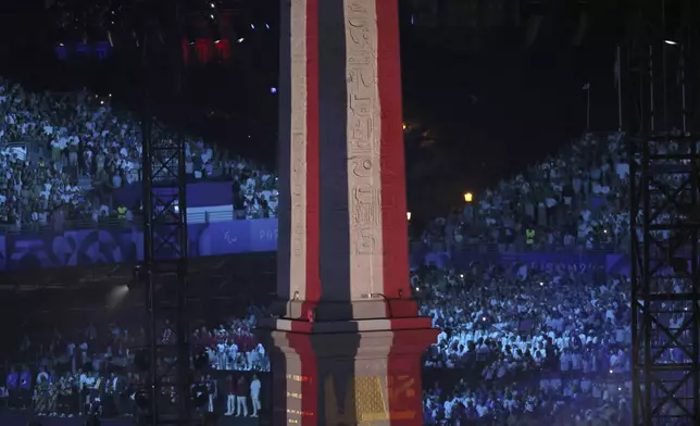 The Obelisk of La Concorde plaza bears the colors of the French flag during the Opening Ceremony for the 2024 Paralympics, Wednesday, Aug. 28, 2024, in Paris, France. (AP Photo/Thomas Padilla)