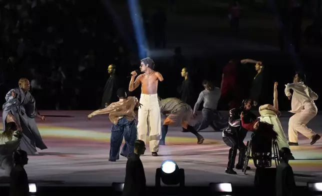 French artist Lucky Love sings during the Opening Ceremony for the 2024 Paralympics, Wednesday, Aug. 28, 2024, in Paris, France. (AP Photo/Michel Euler)