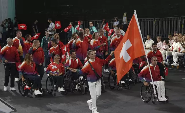 Members of the Swiss delegation parade during the Opening Ceremony for the 2024 Paralympics, Wednesday, Aug. 28, 2024, in Paris, France. (AP Photo/Thibault Camus, Pool)