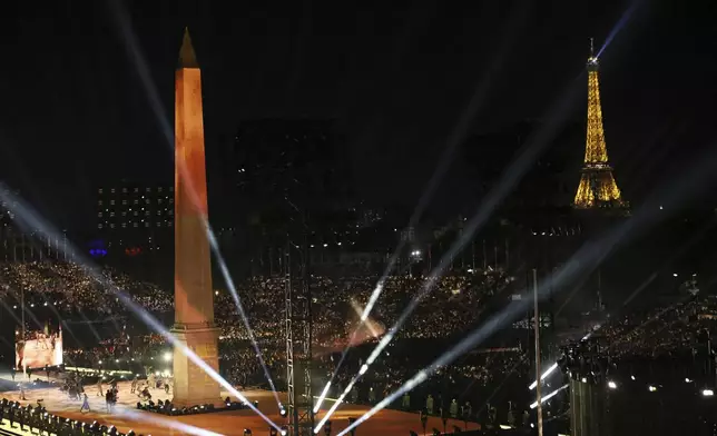 The Obelisk of La Concorde plaza and the Eiffel Tower get lightenings during the Opening Ceremony for the 2024 Paralympics, Wednesday, Aug. 28, 2024, on La Concorde plaza in Paris, France. (AP Photo/Thomas Padilla)