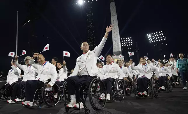 Members of the Japanese delegation parade during the Opening Ceremony for the 2024 Paralympics, Wednesday, Aug. 28, 2024, on Concorde plaza in Paris, France. (AP Photo/Christophe Ena)