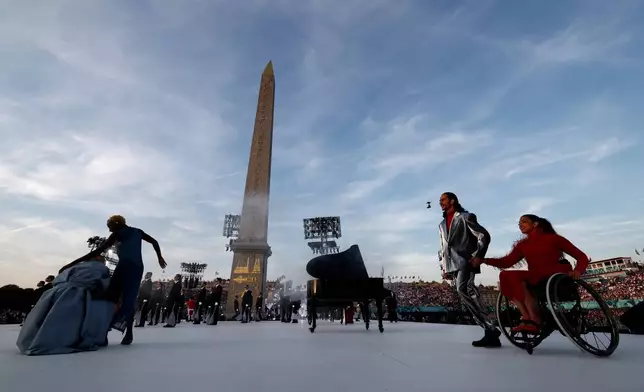 Artists perform during the Opening Ceremony for the 2024 Paralympics, Wednesday, Aug. 28, 2024, in Paris, France. (Gonzalo Fuentes/Pool Photo via AP)