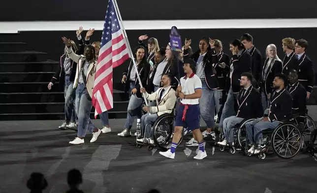 The United States athletes parade during the Opening Ceremony for the 2024 Paralympics, Wednesday, Aug. 28, 2024, in Paris, France. (AP Photo/Michel Euler)