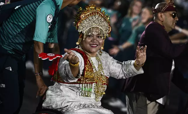 Indonesia's delegation arrives during the Parade of Nations as part of the Paris 2024 Paralympic Games Opening Ceremony at the Place de la Concorde in Paris, France, Wednesday Aug. 28, 2024. (Julien De Rosa/Pool Photo via AP)