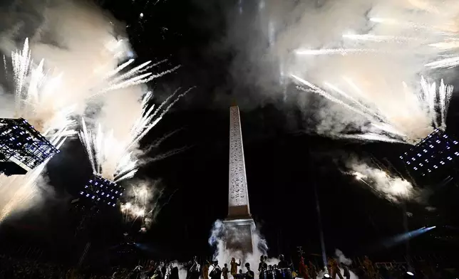 Artists perform with fireworks during the Paris 2024 Paralympic Opening Ceremony at the Place de la Concorde in Paris, France, Wednesday, Aug. 28, 2024. (Julien De Rosa/Pool Photo via AP)