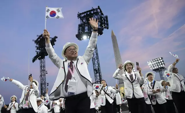 Member of the South Korea delegation parade during the Opening Ceremony for the 2024 Paralympics, Wednesday, Aug. 28, 2024, on Concorde plaza in Paris, France. (AP Photo/Christophe Ena)