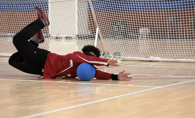 U.S. goalball athlete Zion Walker blocks a shot in practice at the U.S. High Performance Center during the Paralympic Games in Paris on Wednesday, August 28, 2024. Team USA kept their facility open after the conclusion of the Olympic Games. (AP Photo/Mady Mertens)