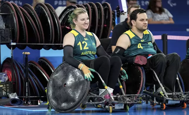 Australians Shae Graham, left, and Jake Howe watch the game on the sideline during the 2024 Paralympics Wheelchair Rugby match Australia against Great Britain at the Champs Mars Arena Thursday, Aug. 29, 2024, in Paris, France. (AP Photo/Michel Euler)