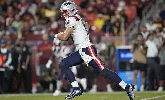 New England Patriots quarterback Drake Maye runs against the Washington Commanders during the first half of a preseason NFL football game, Sunday, Aug. 25, 2024, in Landover, Md. (AP Photo/George Walker IV)