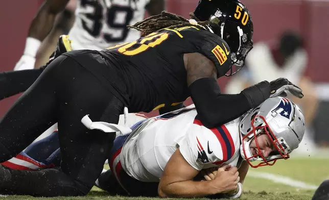 New England Patriots quarterback Drake Maye, bottom, is tackled after recovering his own fumble by Washington Commanders defensive end Andre Jones Jr. during the first half of a preseason NFL football game, Sunday, Aug. 25, 2024, in Landover, Md. (AP Photo/Nick Wass)