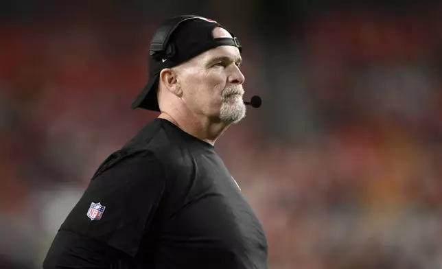 Washington Commanders head coach Dan Quinn watches from the sideline during the first half of a preseason NFL football game against the New England Patriots, Sunday, Aug. 25, 2024, in Landover, Md. (AP Photo/Nick Wass)