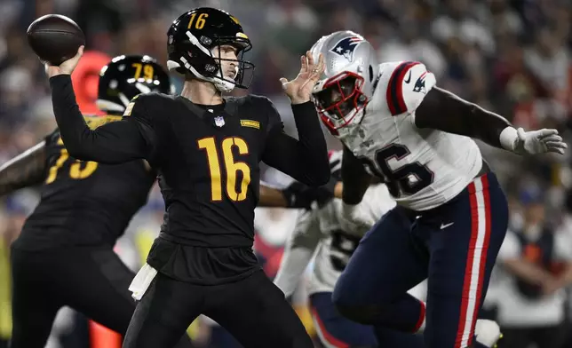 Washington Commanders quarterback Jeff Driskel (16) passes as New England Patriots defensive tackle Sam Roberts applies pressure during the first half of a preseason NFL football game, Sunday, Aug. 25, 2024, in Landover, Md. (AP Photo/Nick Wass)